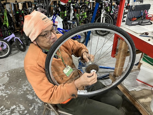 Craig Jeong working on a bicycle wheel