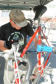 Man behind bicycle on repair stand